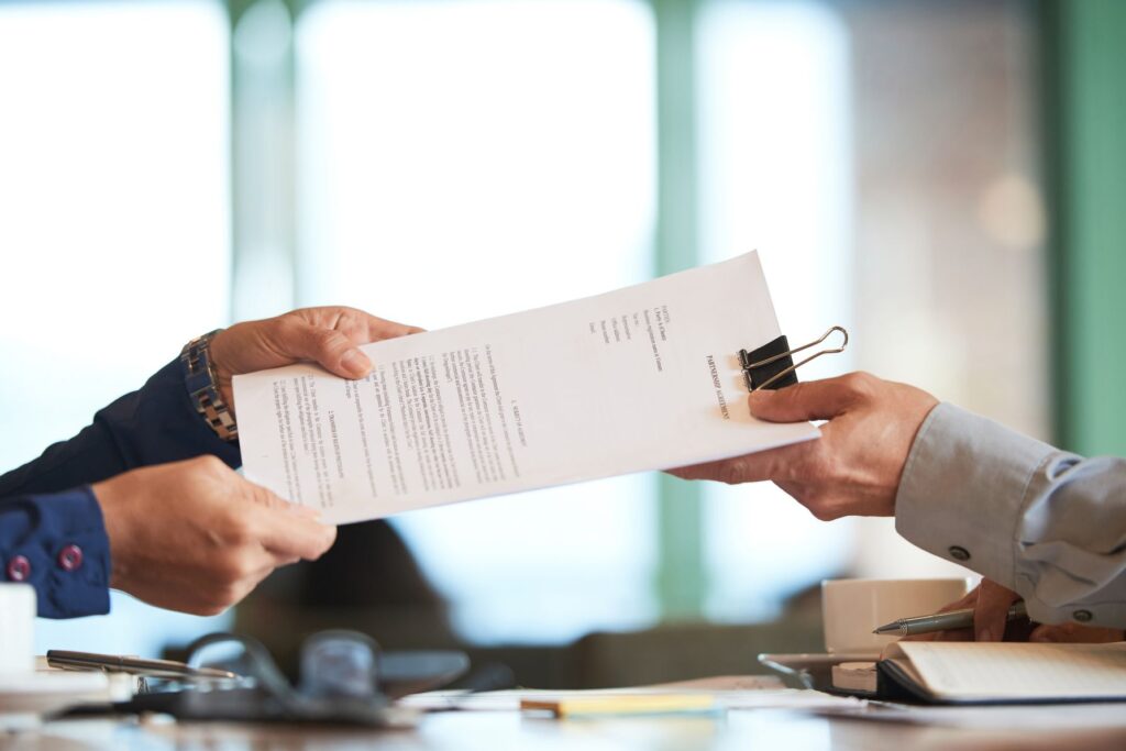 closeup-hands-passing-contract-unrecognizable-businessman (1) (1)