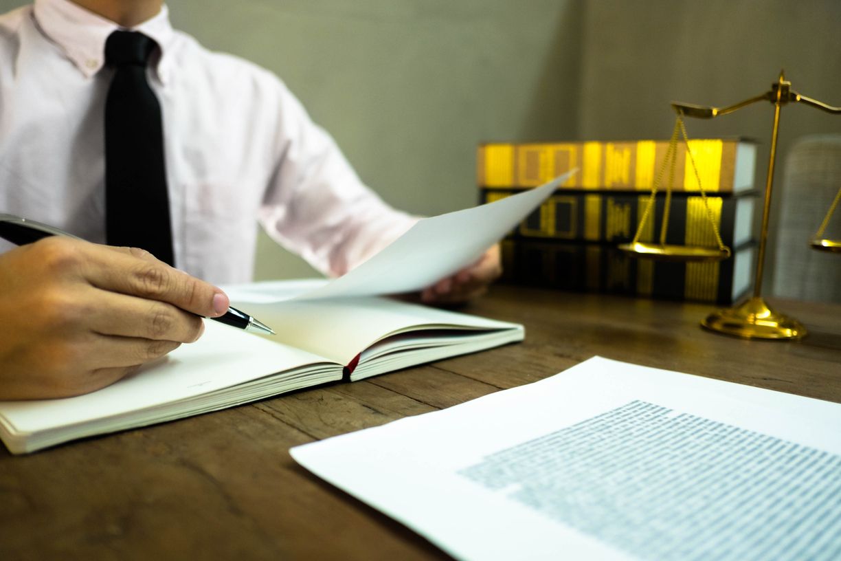 midsection-lawyer-reading-document-desk-office (1)