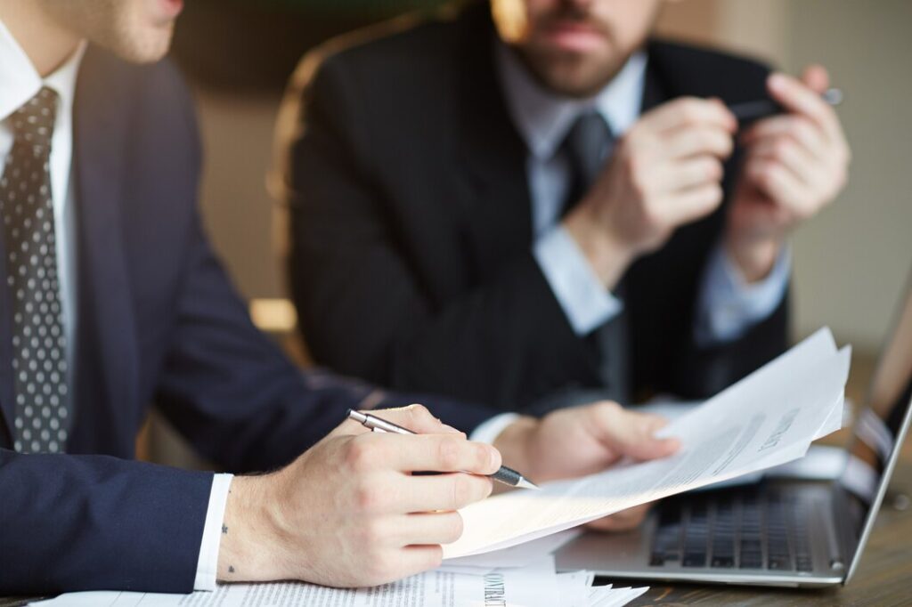 successful-business-partners-discussing-contract_1098-14790